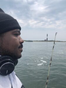 Omar fishing by the water